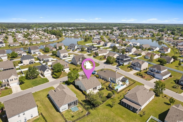 aerial view of residential area featuring a large body of water