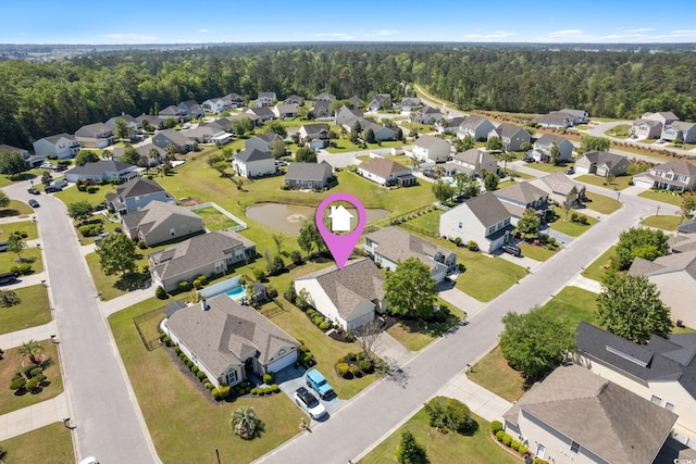 aerial view of residential area featuring a heavily wooded area
