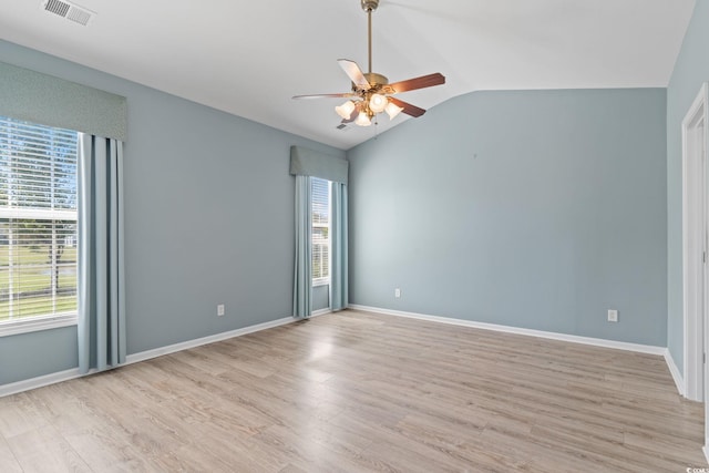 unfurnished room with ceiling fan, light wood-type flooring, lofted ceiling, and baseboards
