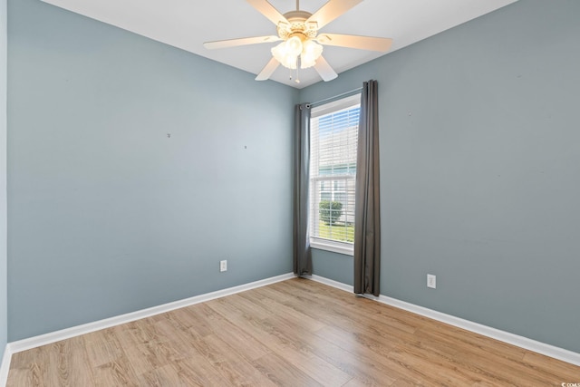 unfurnished room featuring wood finished floors, baseboards, and ceiling fan