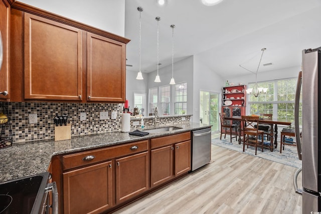 1208 Camlet Ln, Little River, SC 29566 - kitchen with stainless steel appliances, a sink, vaulted ceiling, a chandelier, and tasteful backsplash