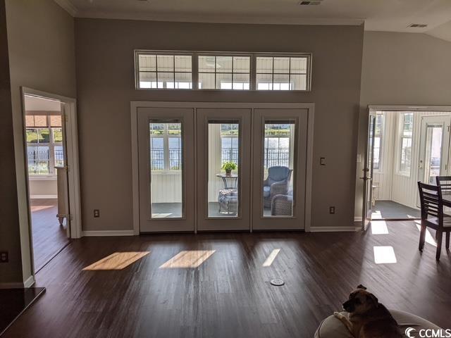 doorway with french doors, baseboards, high vaulted ceiling, and dark wood-type flooring