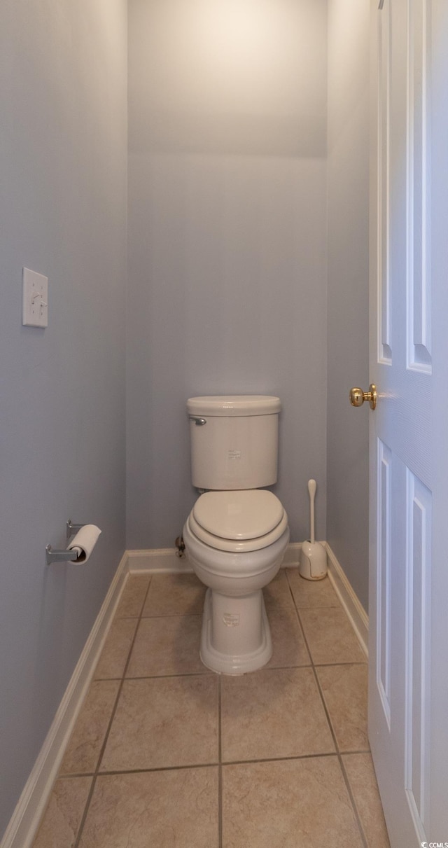 bathroom featuring tile patterned floors, baseboards, and toilet