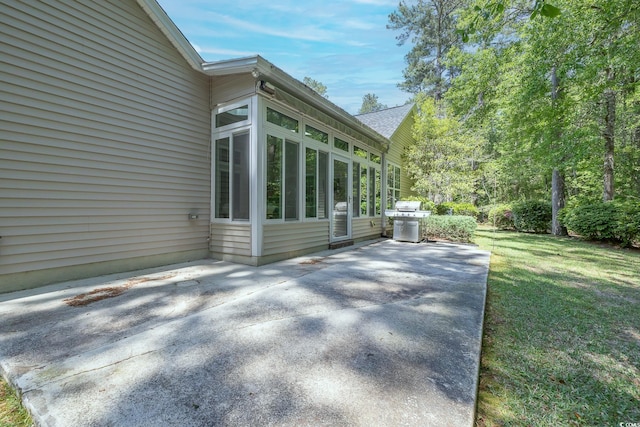 view of home's exterior featuring a patio area and a lawn