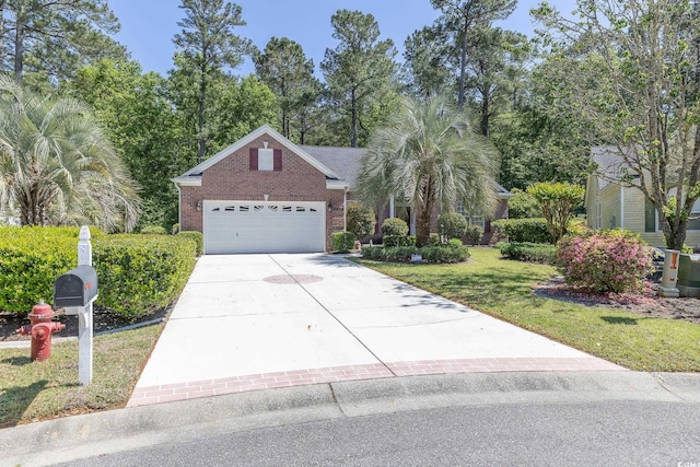 view of front facade with concrete driveway, a front lawn, brick siding, and an attached garage