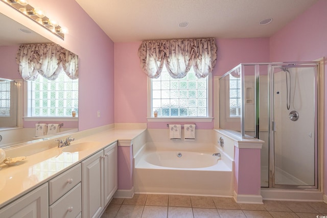 bathroom featuring a garden tub, vanity, tile patterned flooring, and a shower stall