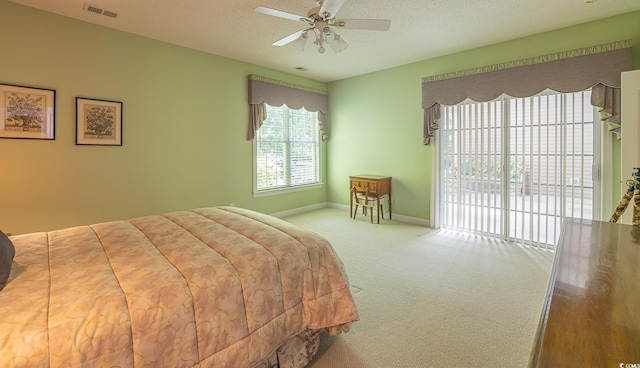 carpeted bedroom with visible vents, baseboards, a textured ceiling, access to outside, and ceiling fan