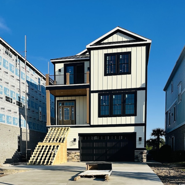 view of front of property with a balcony, board and batten siding, a garage, and driveway
