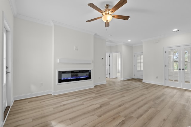 unfurnished living room with recessed lighting, ceiling fan, light wood-style flooring, a glass covered fireplace, and crown molding