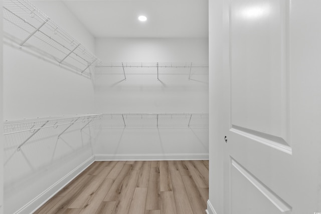walk in closet featuring light wood finished floors
