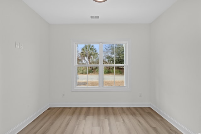 unfurnished room with light wood-style flooring and baseboards