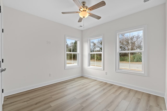 empty room with light wood-type flooring, ceiling fan, and baseboards