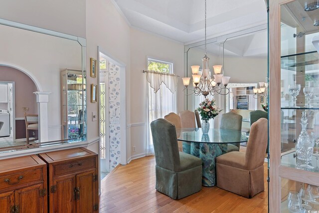 321 Heather Ct, Sunset Beach, NC 28468 - dining area featuring a chandelier, light wood-style flooring, and baseboards