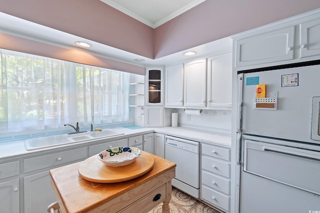 321 Heather Ct, Sunset Beach, NC 28468 - kitchen featuring crown molding, white cabinets, a sink, light countertops, and white dishwasher