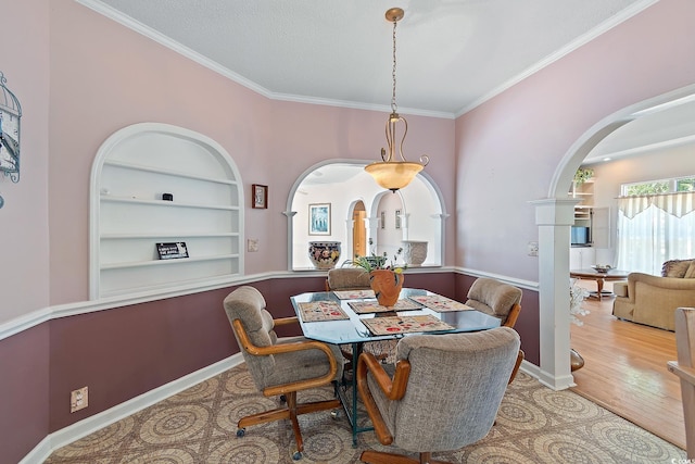 321 Heather Ct, Sunset Beach, NC 28468 - dining space featuring crown molding, baseboards, arched walkways, wood finished floors, and built in features