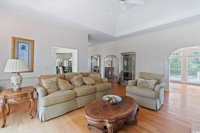 321 Heather Ct, Sunset Beach, NC 28468 - living room featuring a towering ceiling, light wood-style floors, ceiling fan with notable chandelier, and arched walkways
