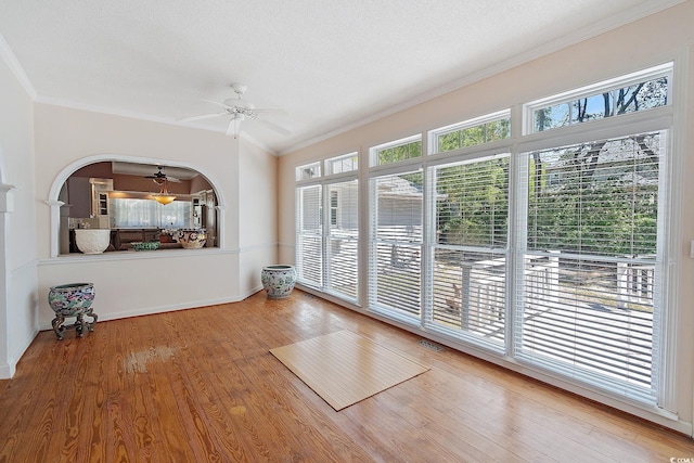 321 Heather Ct, Sunset Beach, NC 28468 - unfurnished living room featuring wood finished floors, ornamental molding, baseboards, visible vents, and a ceiling fan