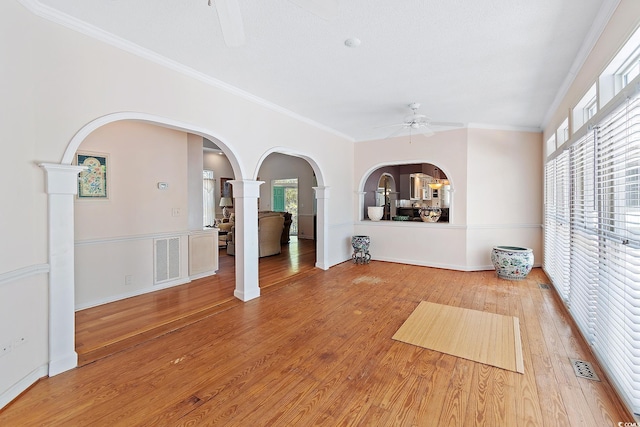 321 Heather Ct, Sunset Beach, NC 28468 - interior space featuring arched walkways, wood finished floors, decorative columns, visible vents, and a ceiling fan