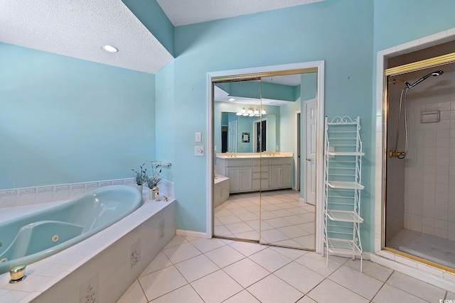 321 Heather Ct, Sunset Beach, NC 28468 - full bathroom with a tub with jets, tile patterned flooring, an inviting chandelier, and a shower stall