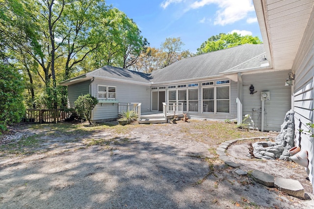 321 Heather Ct, Sunset Beach, NC 28468 - rear view of house featuring a wooden deck and a shingled roof