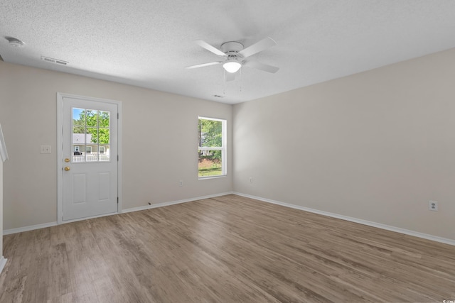 622 Oakhurst Dr, Myrtle Beach, SC 29579 - spare room featuring light wood finished floors, plenty of natural light, ceiling fan, baseboards, and a textured ceiling