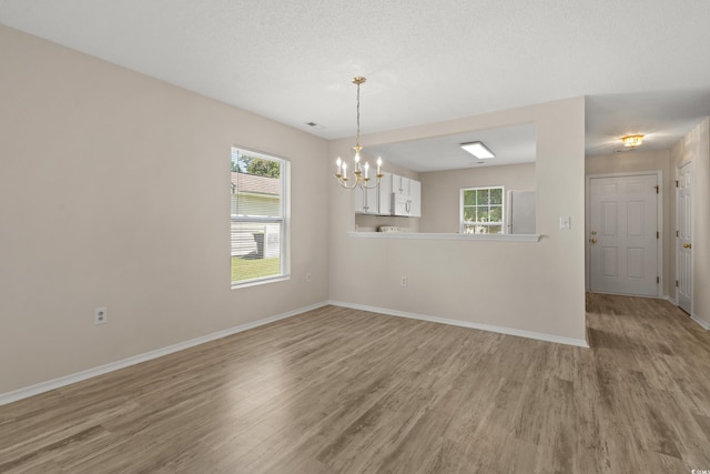 622 Oakhurst Dr, Myrtle Beach, SC 29579 - unfurnished room featuring light wood-style flooring, baseboards, and a chandelier