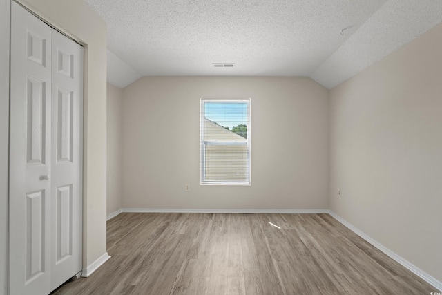 622 Oakhurst Dr, Myrtle Beach, SC 29579 - unfurnished bedroom featuring wood finished floors, vaulted ceiling, a textured ceiling, baseboards, and a closet