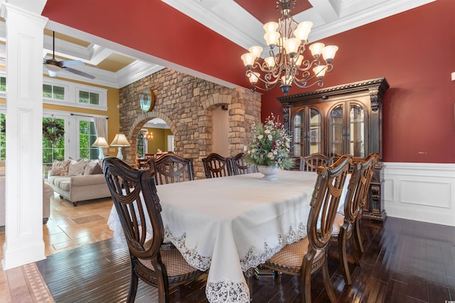 8008 Mcsweeney Ct, Myrtle Beach, SC 29588 - dining room featuring a high ceiling, arched walkways, ceiling fan with notable chandelier, ornate columns, and ornamental molding