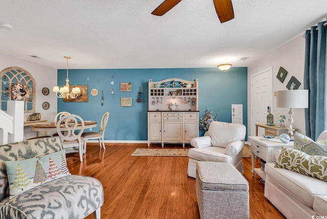 1046 Palisade Cir Unit 1046, Myrtle Beach, SC 29577 - living area featuring a ceiling fan, a textured ceiling, a chandelier, light wood-style floors, and baseboards