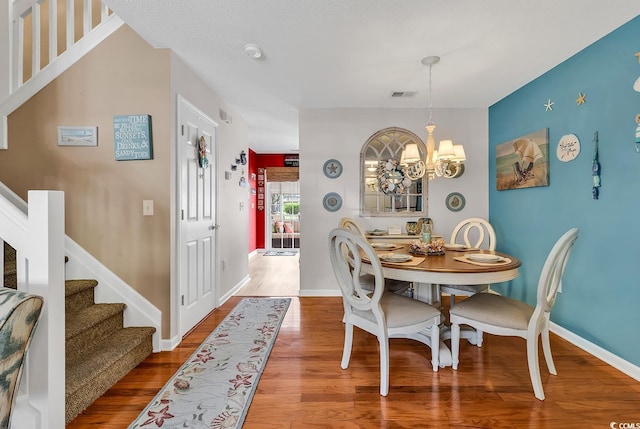 1046 Palisade Cir Unit 1046, Myrtle Beach, SC 29577 - dining area with a chandelier, stairway, wood finished floors, and baseboards