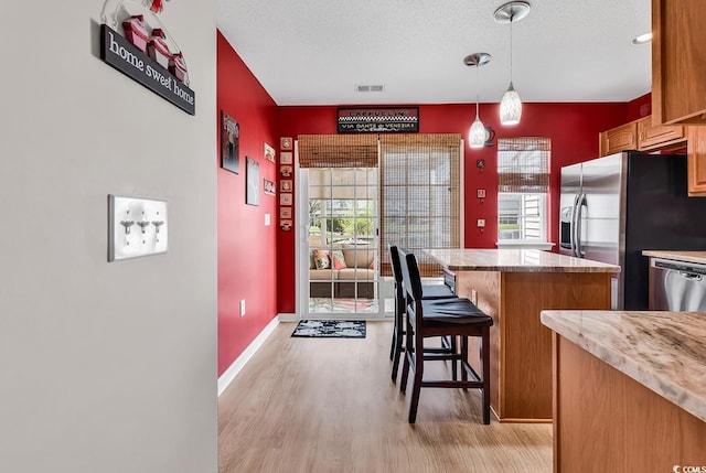 1046 Palisade Cir Unit 1046, Myrtle Beach, SC 29577 - kitchen featuring a center island, light wood-style flooring, stainless steel appliances, light countertops, and a kitchen breakfast bar