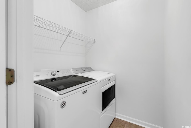 1046 Palisade Cir Unit 1046, Myrtle Beach, SC 29577 - laundry room with independent washer and dryer, baseboards, light wood-style floors, and a textured ceiling