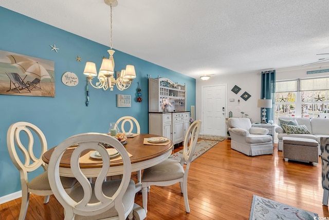 1046 Palisade Cir Unit 1046, Myrtle Beach, SC 29577 - dining room featuring a chandelier, light wood finished floors, and a textured ceiling