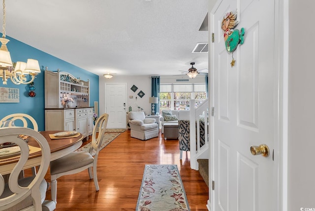 1046 Palisade Cir Unit 1046, Myrtle Beach, SC 29577 - living area featuring ceiling fan, wood finished floors, stairs, a textured ceiling, and a chandelier