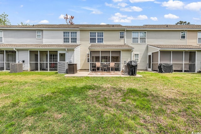 1046 Palisade Cir Unit 1046, Myrtle Beach, SC 29577 - rear view of house with a sunroom, a patio area, a lawn, and central AC unit