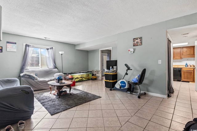 living area featuring a textured ceiling and light tile patterned floors