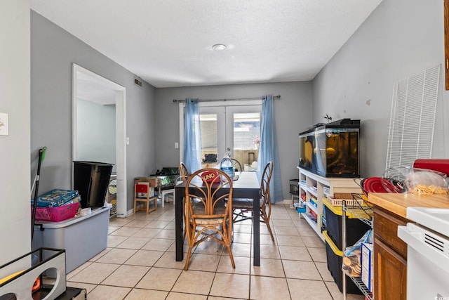 dining space with visible vents and light tile patterned floors