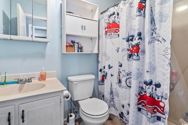 bathroom with vanity, a shower with shower curtain, and toilet