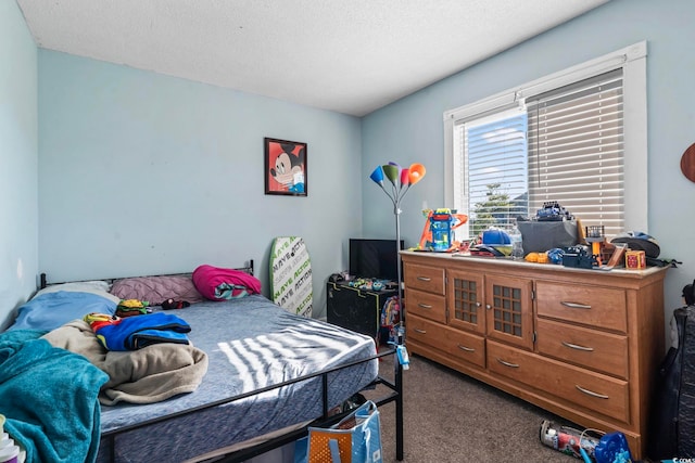 bedroom with carpet floors and a textured ceiling