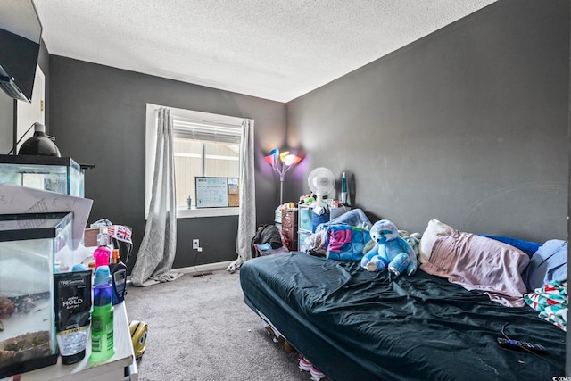 bedroom featuring carpet and a textured ceiling