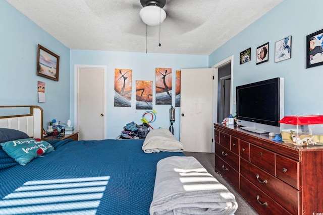 carpeted bedroom featuring a textured ceiling and ceiling fan