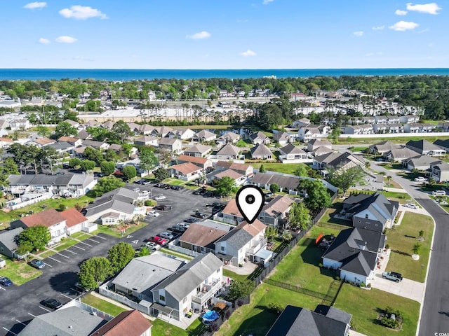 drone / aerial view featuring a water view and a residential view