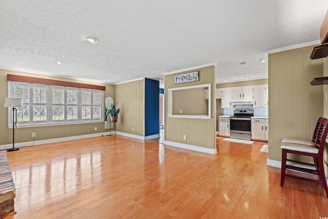 5033 Brantwood Dr, Mullins, SC 29574 - unfurnished living room featuring light wood finished floors, baseboards, a textured ceiling, and ornamental molding