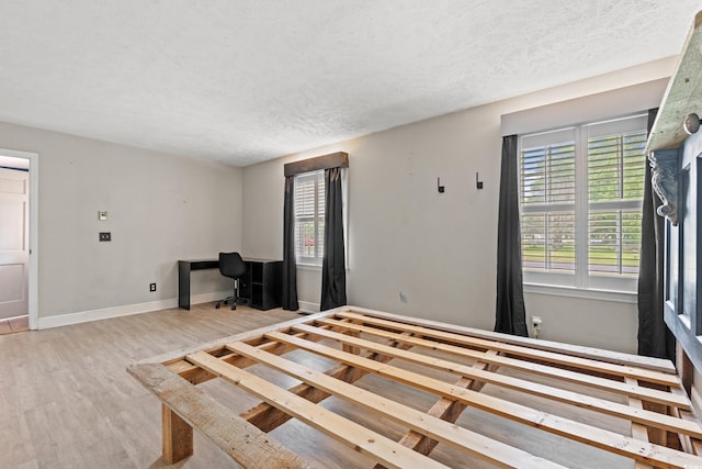 5033 Brantwood Dr, Mullins, SC 29574 - unfurnished bedroom with baseboards, wood finished floors, and a textured ceiling
