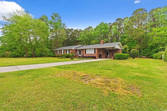 5033 Brantwood Dr, Mullins, SC 29574 - single story home featuring concrete driveway, a front lawn, brick siding, and a chimney
