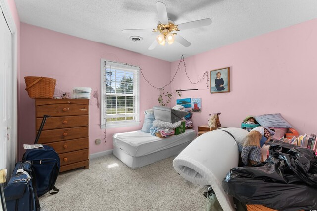 414 Staghorn Ln, Longs, SC 29568 - carpeted bedroom with a ceiling fan, visible vents, a textured ceiling, and a closet