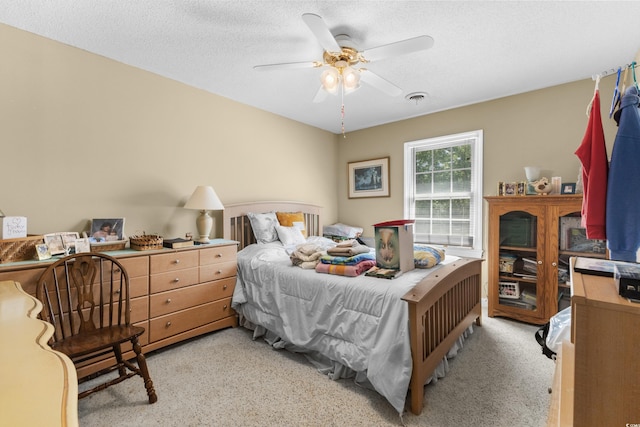 bedroom featuring ceiling fan, a textured ceiling, and visible vents