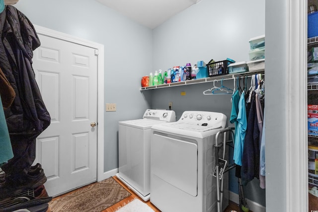 laundry area featuring washing machine and dryer, baseboards, and laundry area