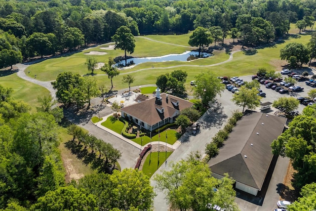 drone / aerial view featuring golf course view and a water view
