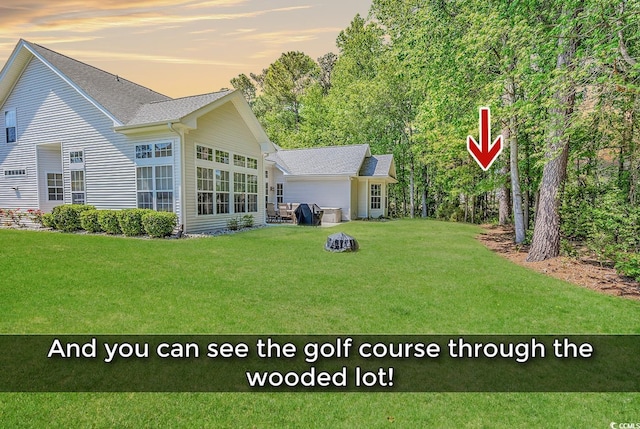 1249 Trent Dr, Murrells Inlet, SC 29576 - back of property at dusk with a yard and roof with shingles